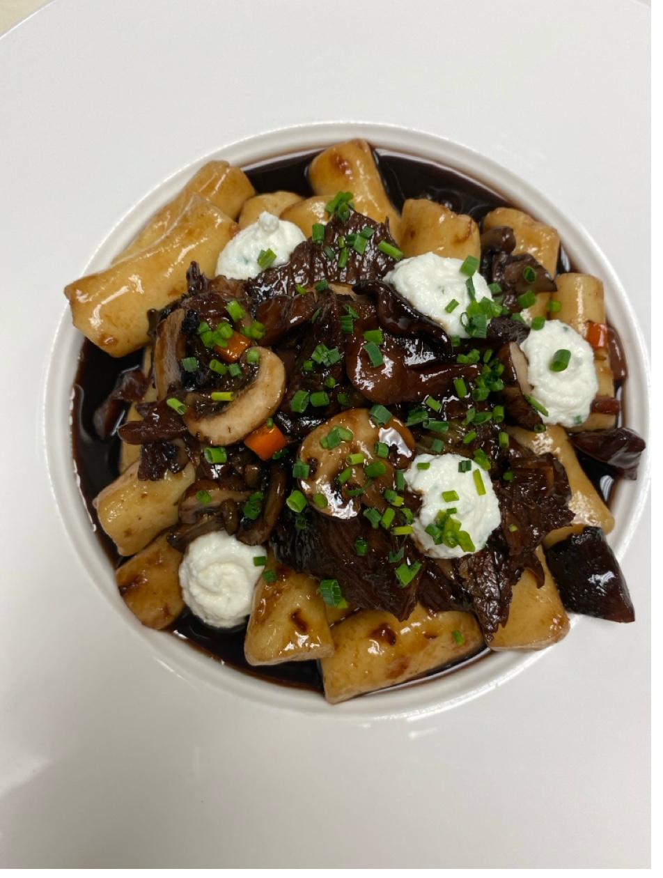 Braised short rib with gnocchi, wild mushrooms, fresh ricotta dollops, and chives