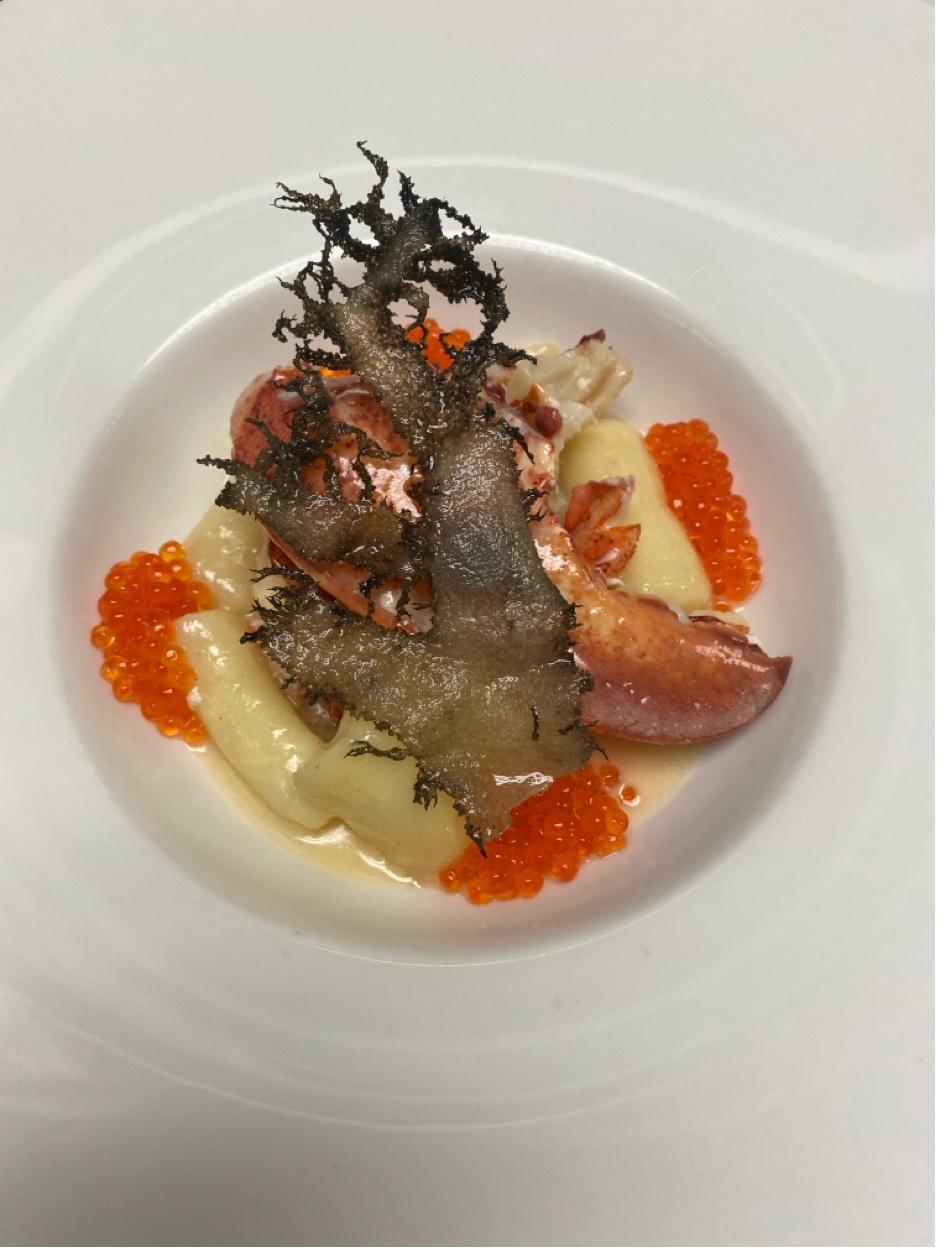 Butter poached lobster on parsnip puree with salmon roe and crispy seaweed garnish